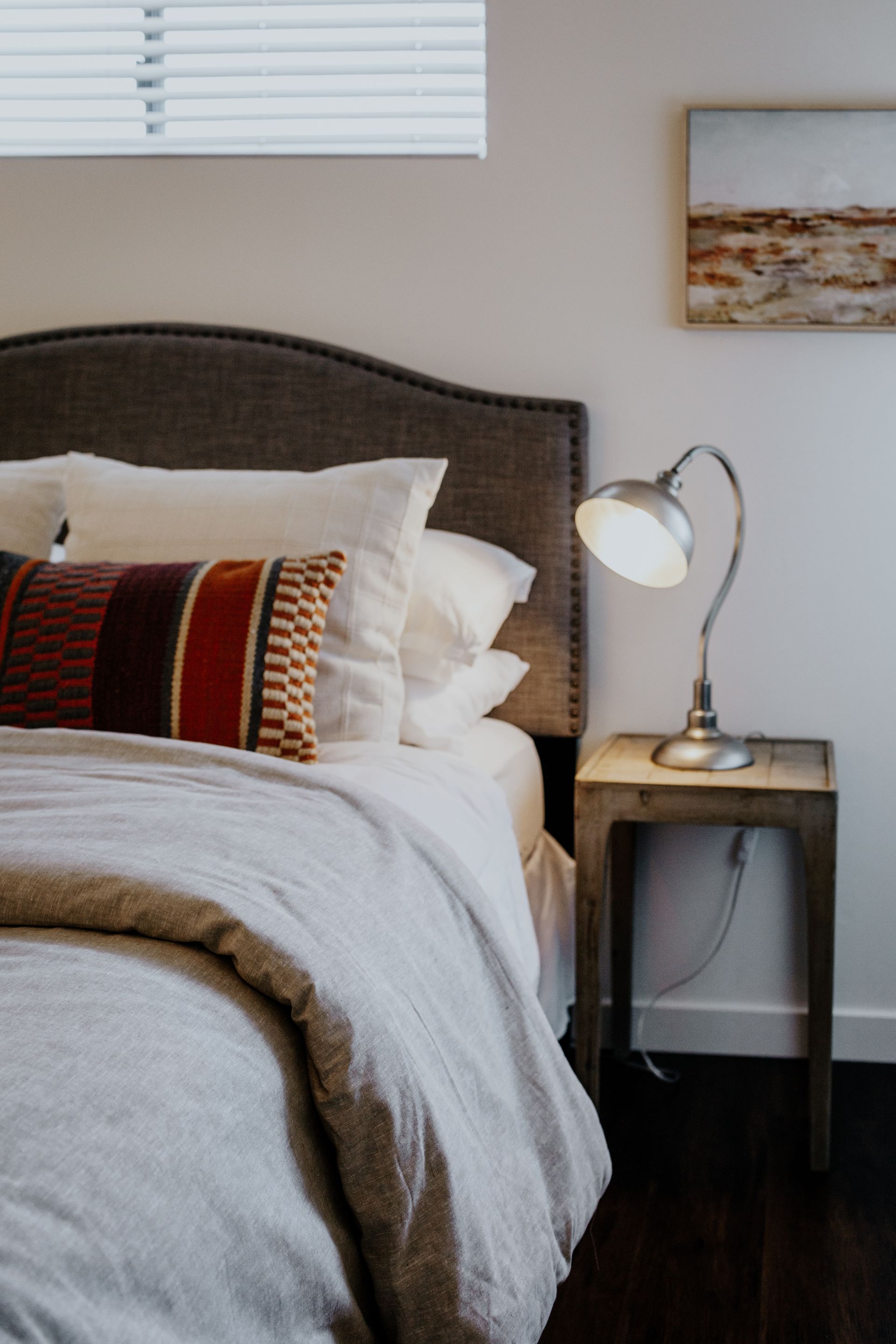 Loft bedroom with a queen-sized bed and nightstand.