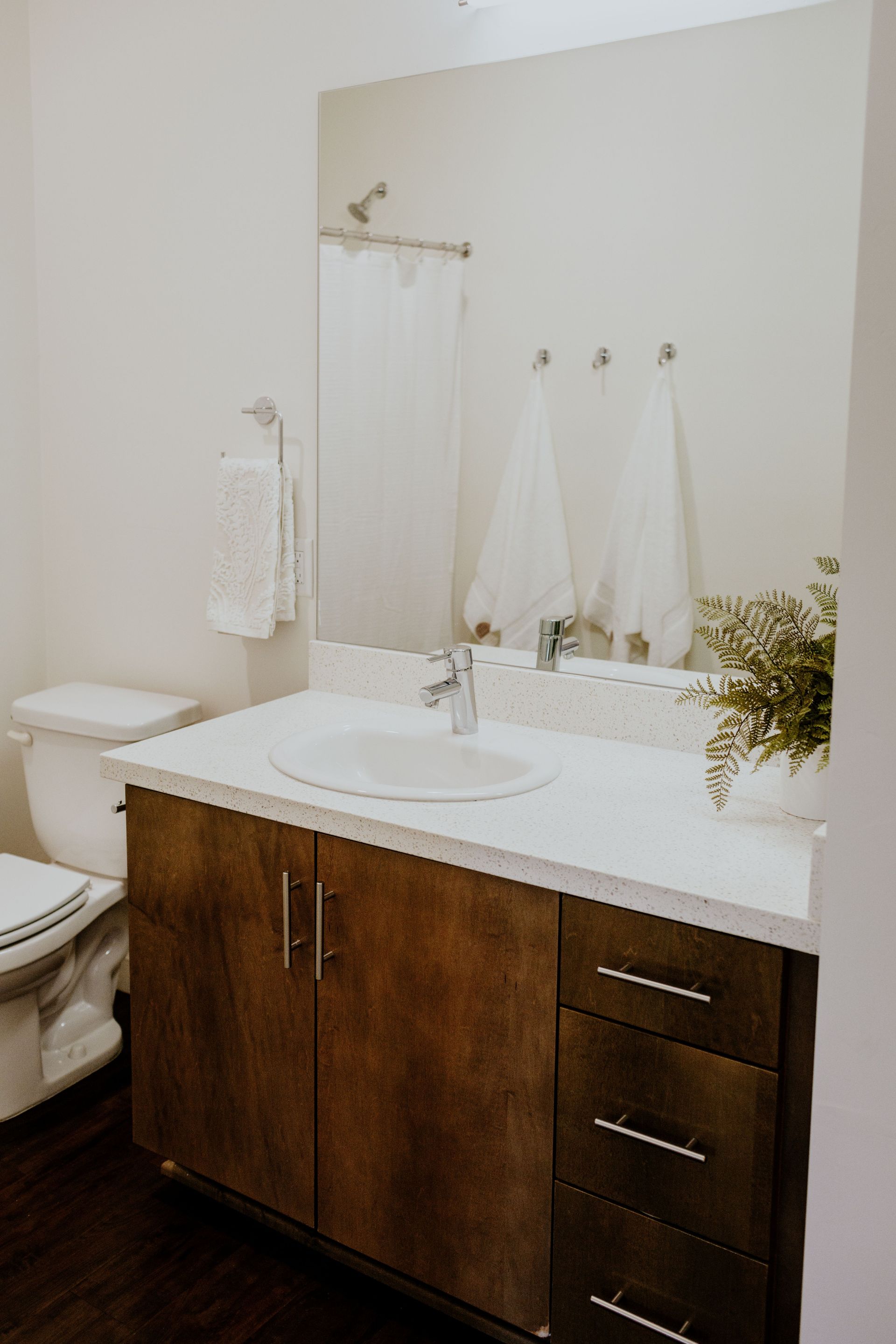 Bathroom with White Quartz countertop and large mirror