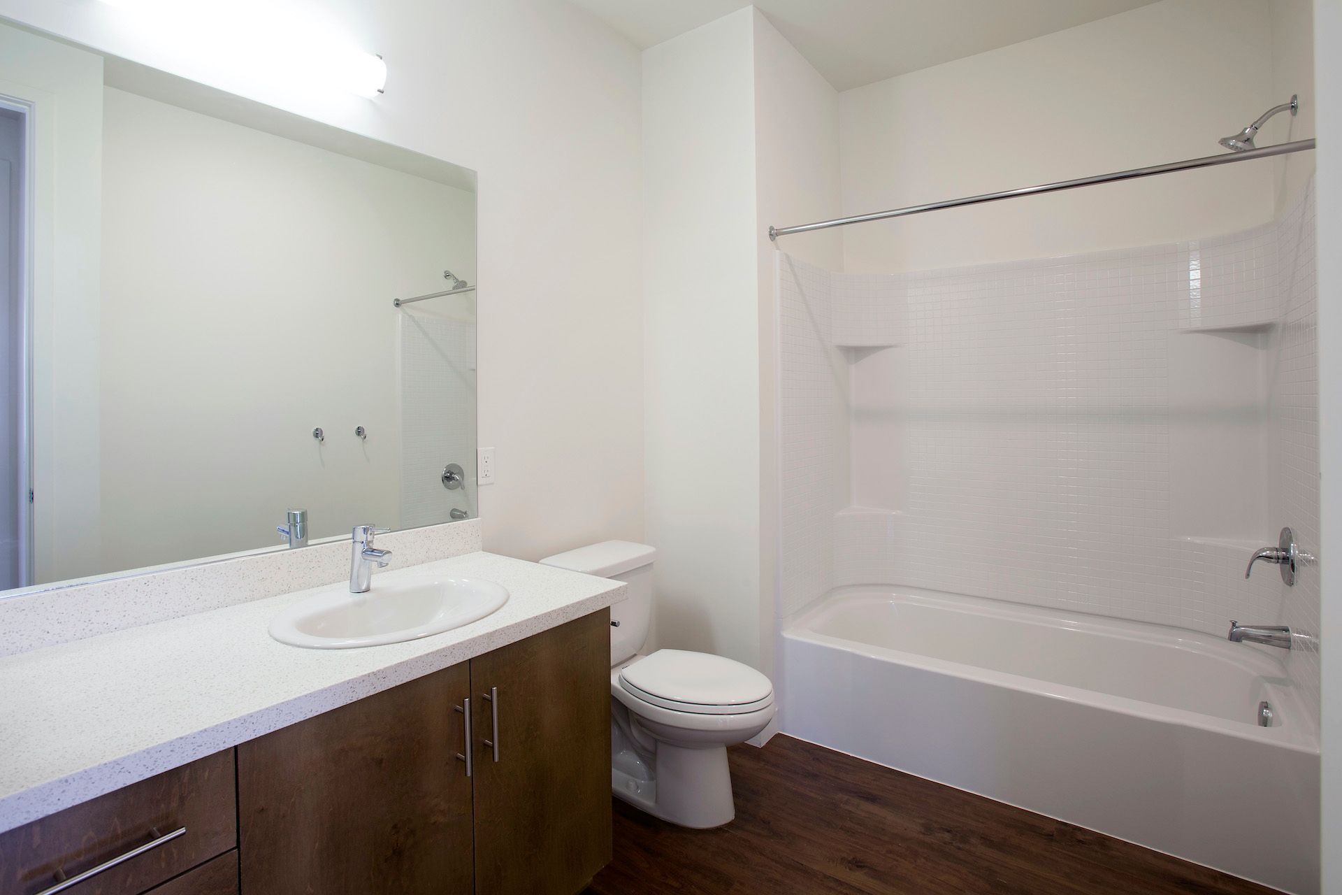A bathroom with a toilet , sink , and bathtub.
