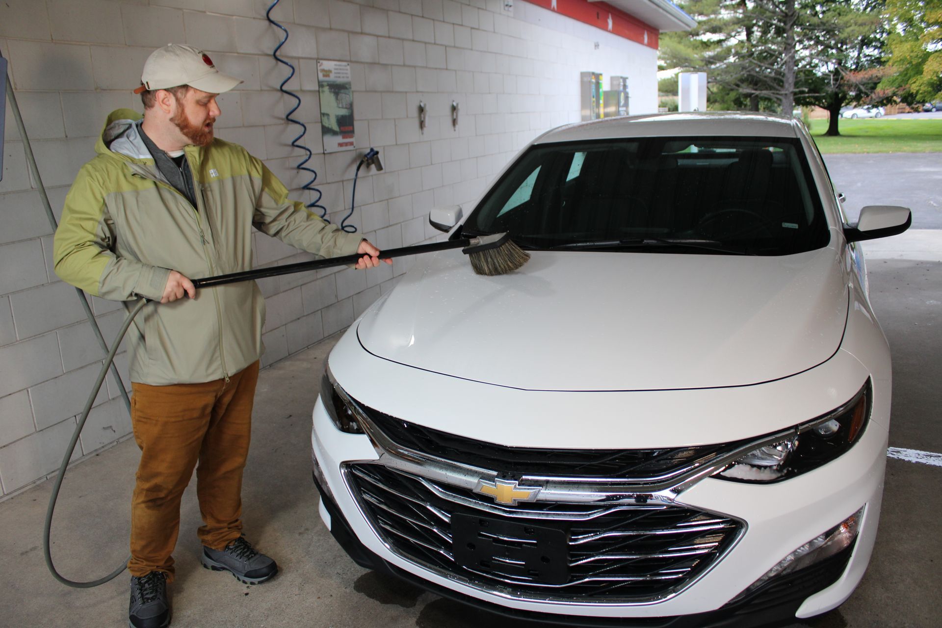 Mike Ohlinger washing a carwash for photography in self serve carwash bay