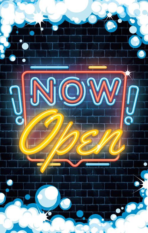 A neon sign that says `` now open '' on a brick wall surrounded by bubbles.