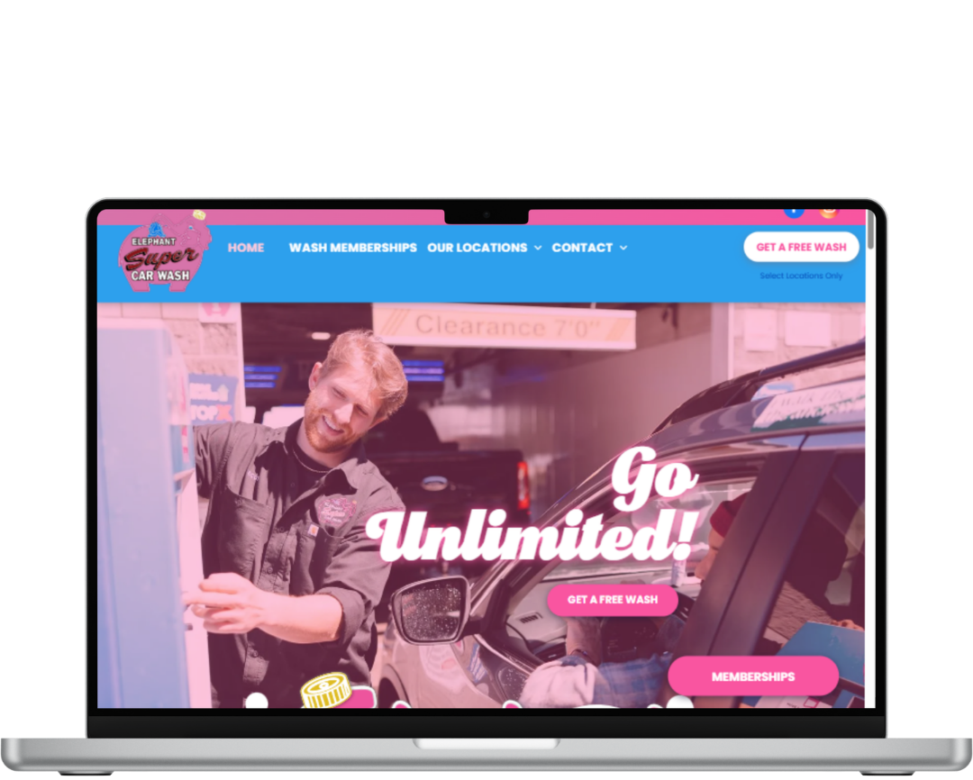 Laptop displaying a colorful website with “Go Unlimited!” over a man leaning beside a car in a garage.