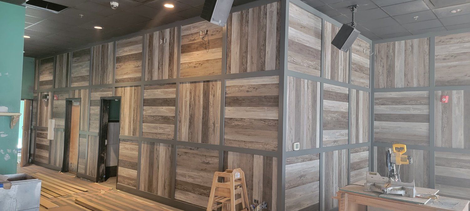 A room with a wooden wall and a wooden table