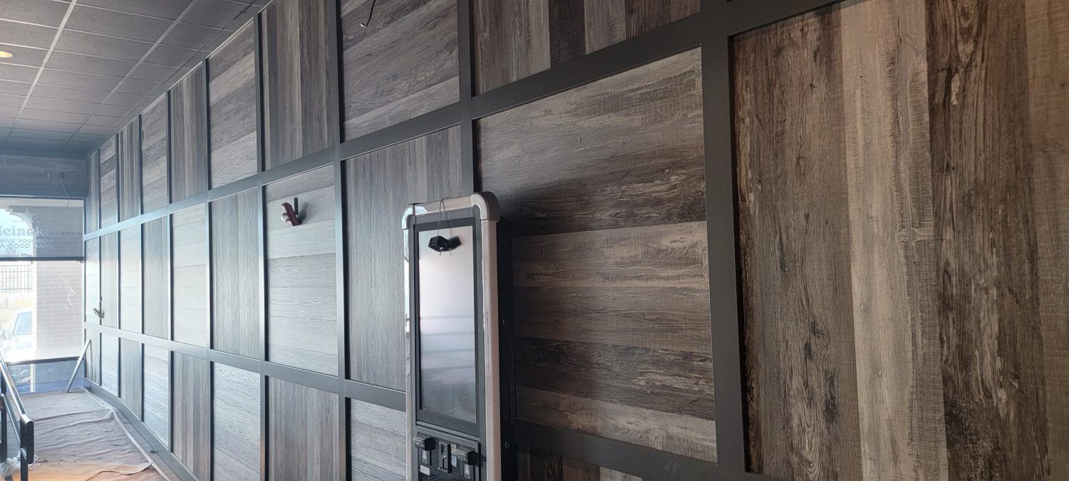 A hallway with a wooden wall and a metal door