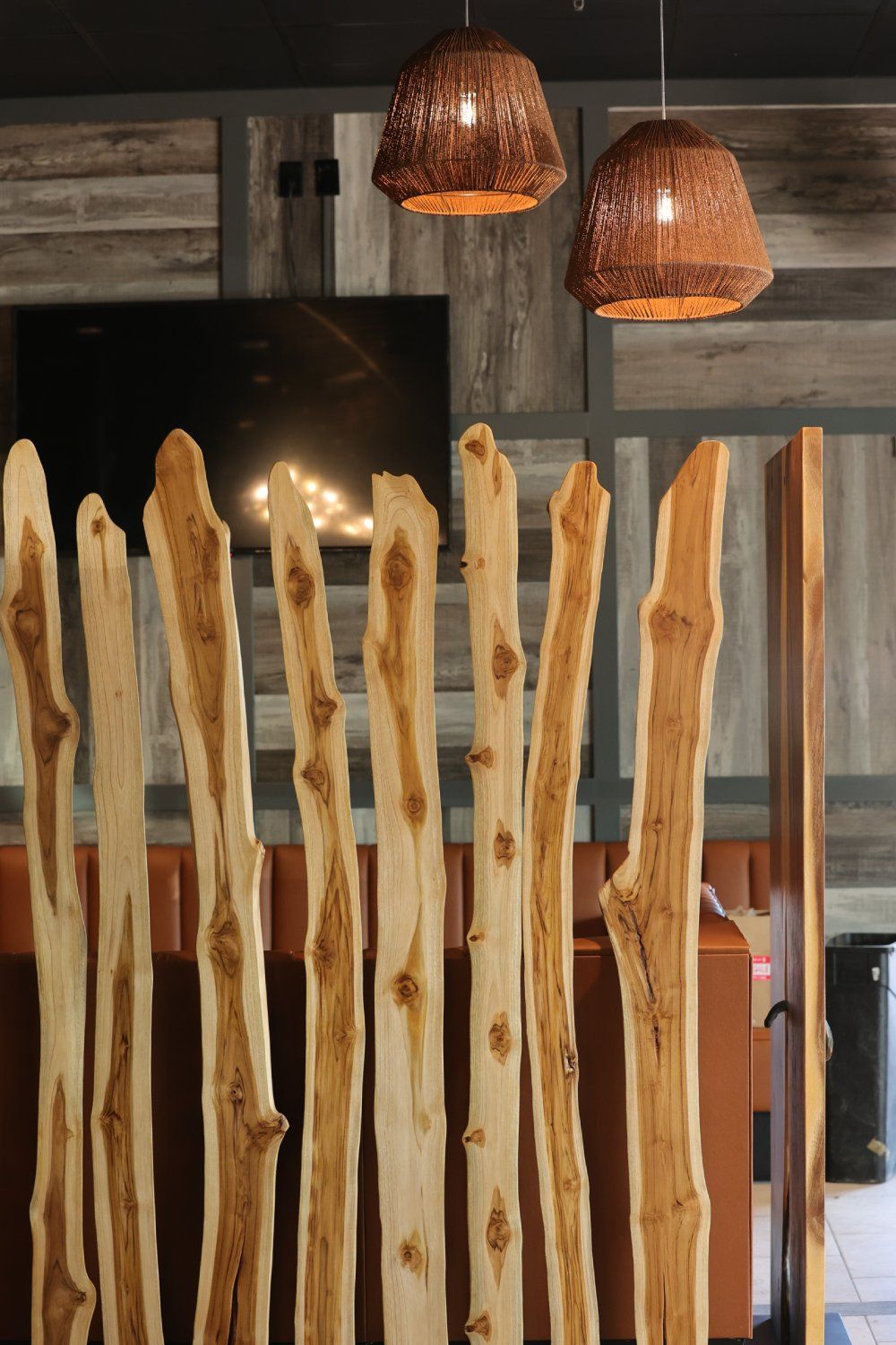 A wooden fence with a fireplace in the background
