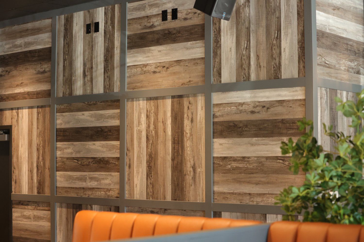 A wooden wall with a couch in front of it