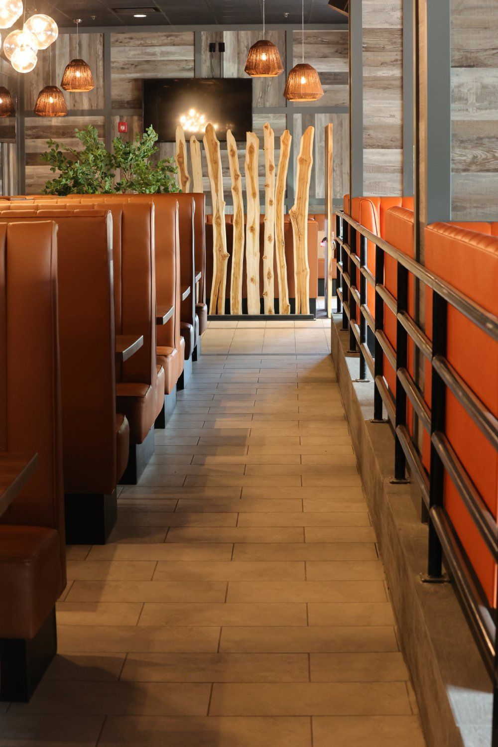 A row of booths in a restaurant with a wooden divider