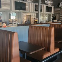 A diner with brown leather booths and tables