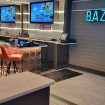 It is a bar with a lot of televisions on the wall