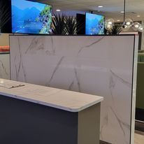 There is a marble counter top in the middle of the room