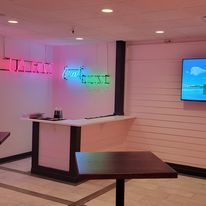 A room with tables and a television on the wall