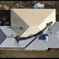 An aerial view of a roof with a statue of a fish on it