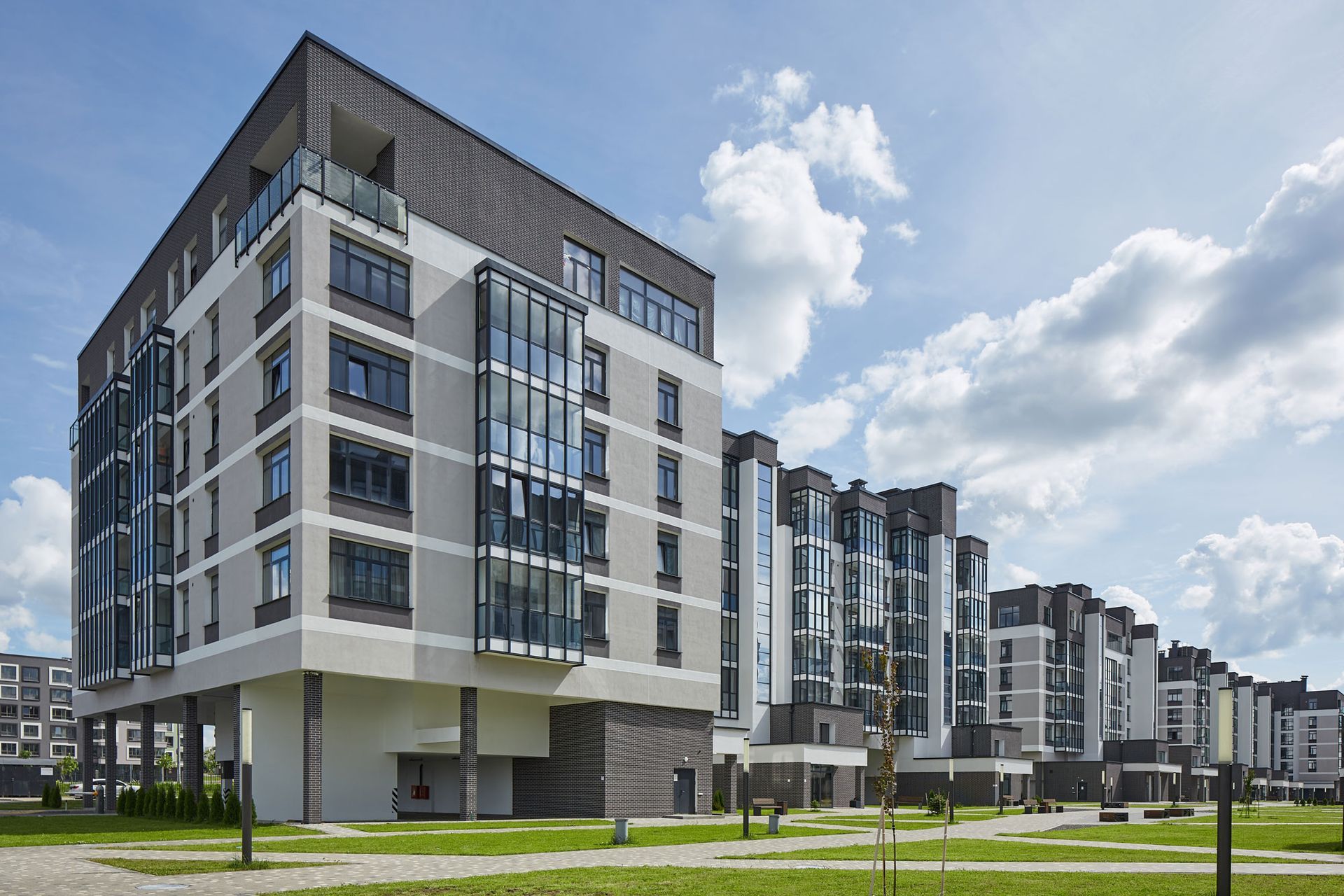 A large apartment building with a lot of windows in a residential area