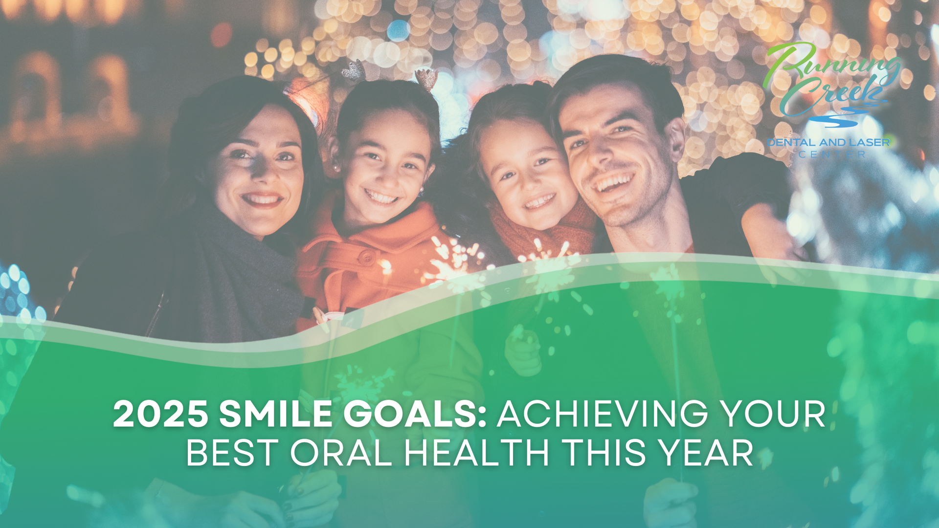 A family is smiling for a picture in front of christmas lights.