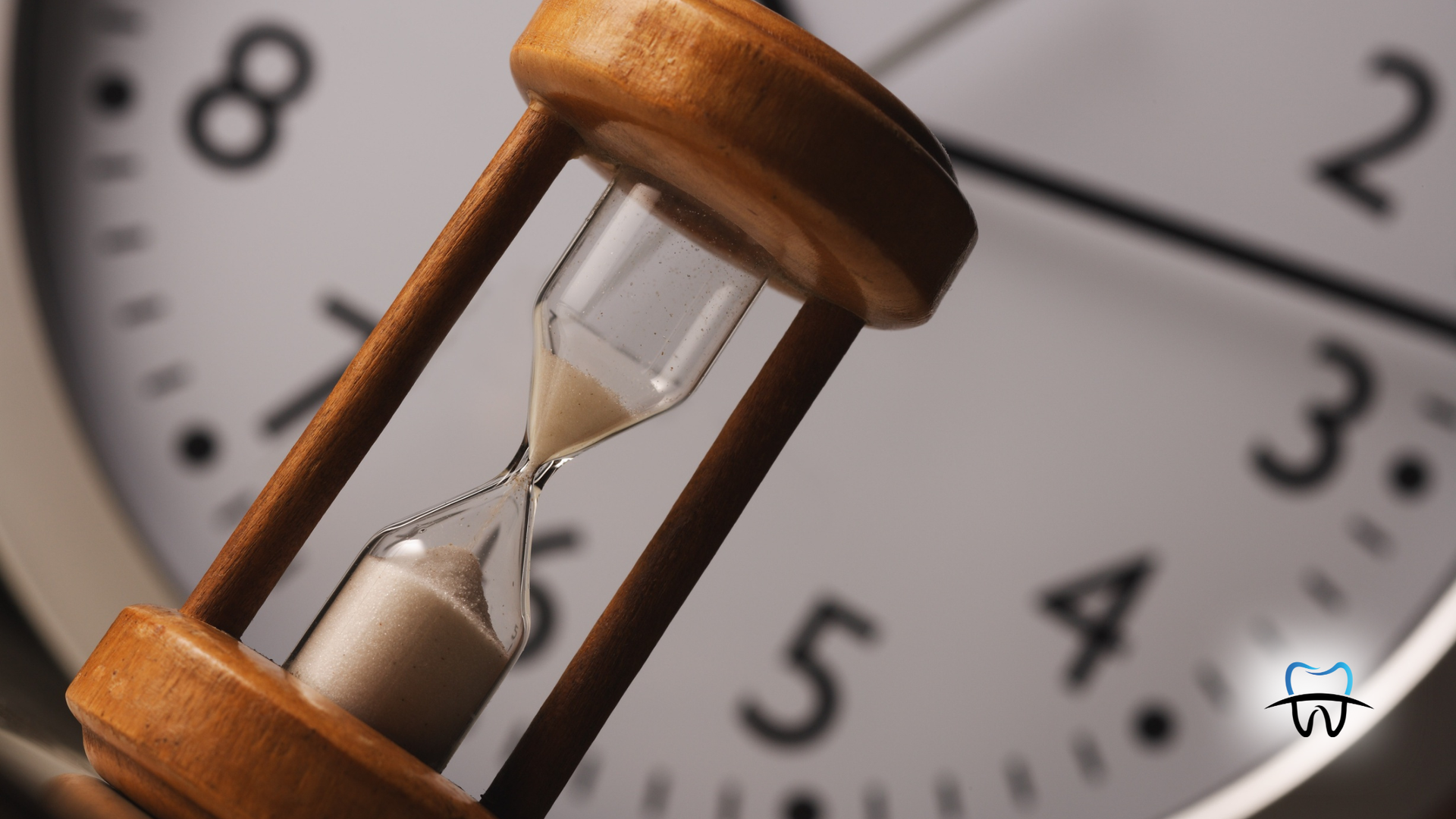 Hourglass in front of a clock, implying a time-sensitive matter, and the urgency of time.