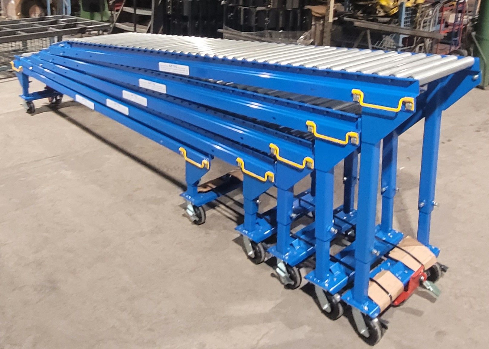 A blue conveyor belt with wheels is stacked on top of each other