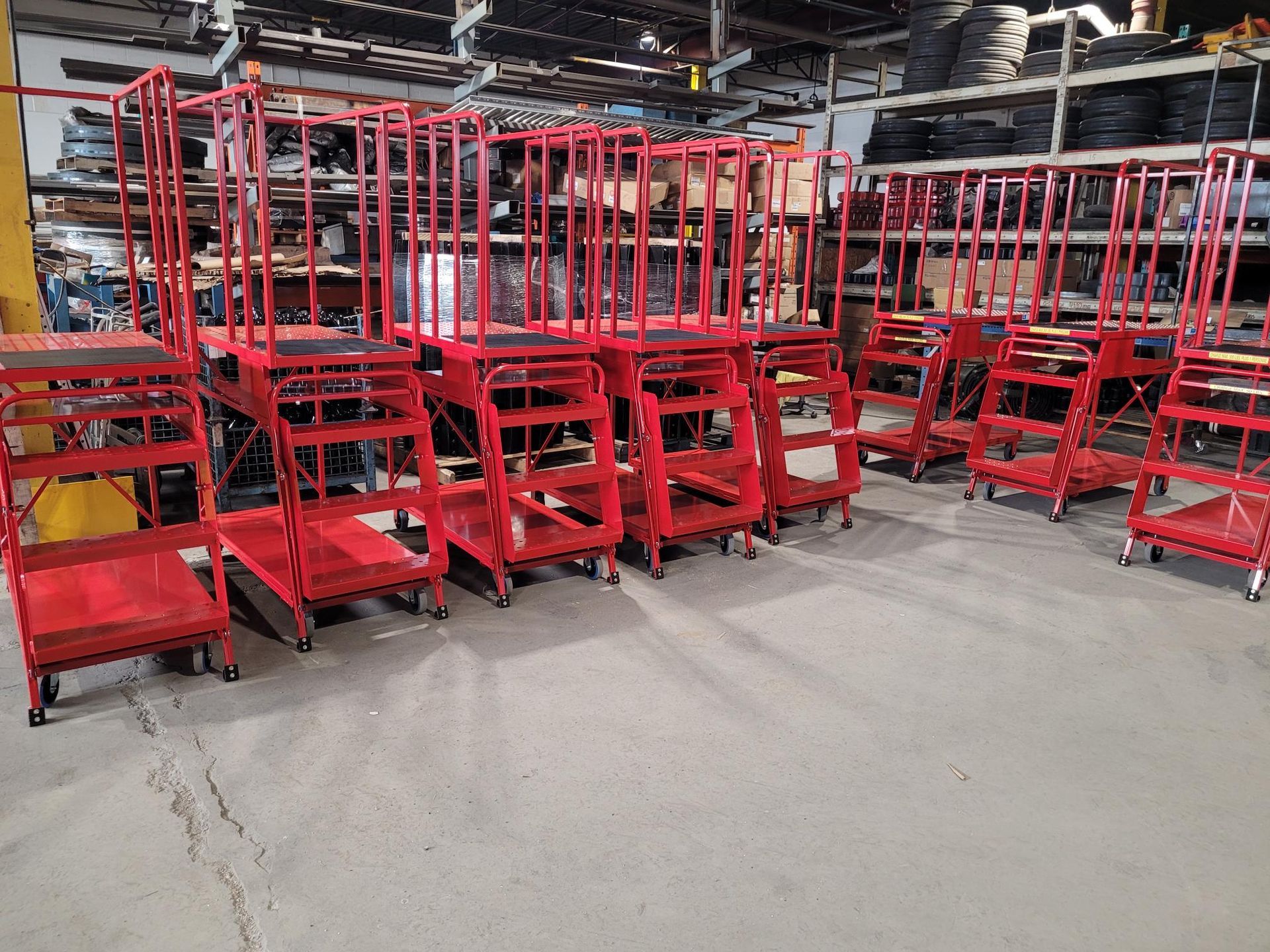 A row of red stairs are lined up in a warehouse.