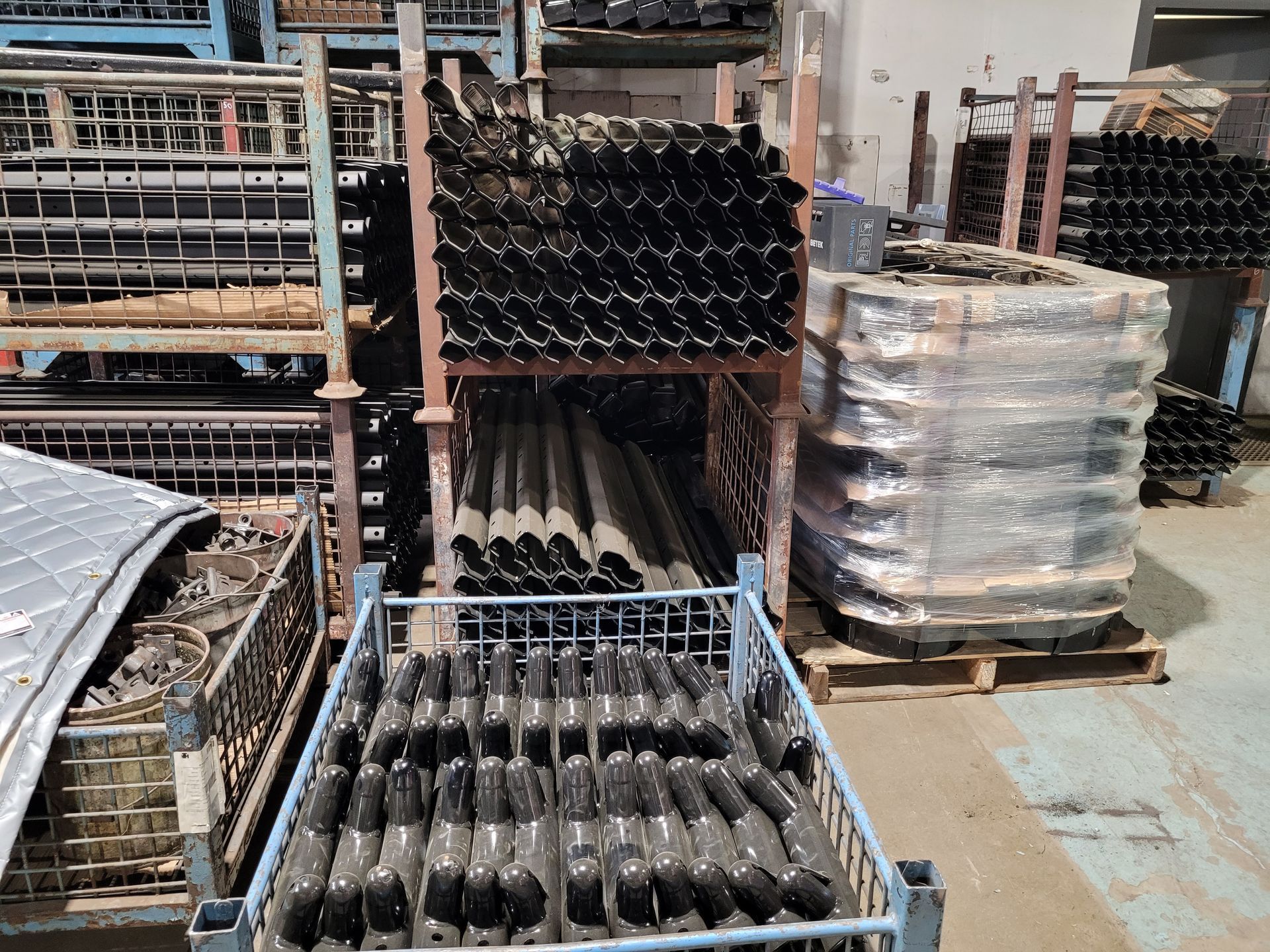 A bunch of black pipes are sitting on top of each other on a table.