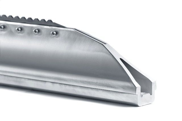 A close up of a metal object on a white background