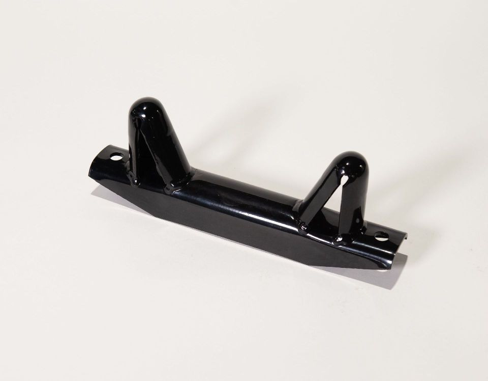 A black metal object is sitting on a white surface.