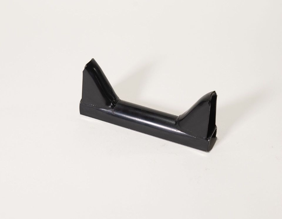 A black plastic handle is sitting on a white surface.