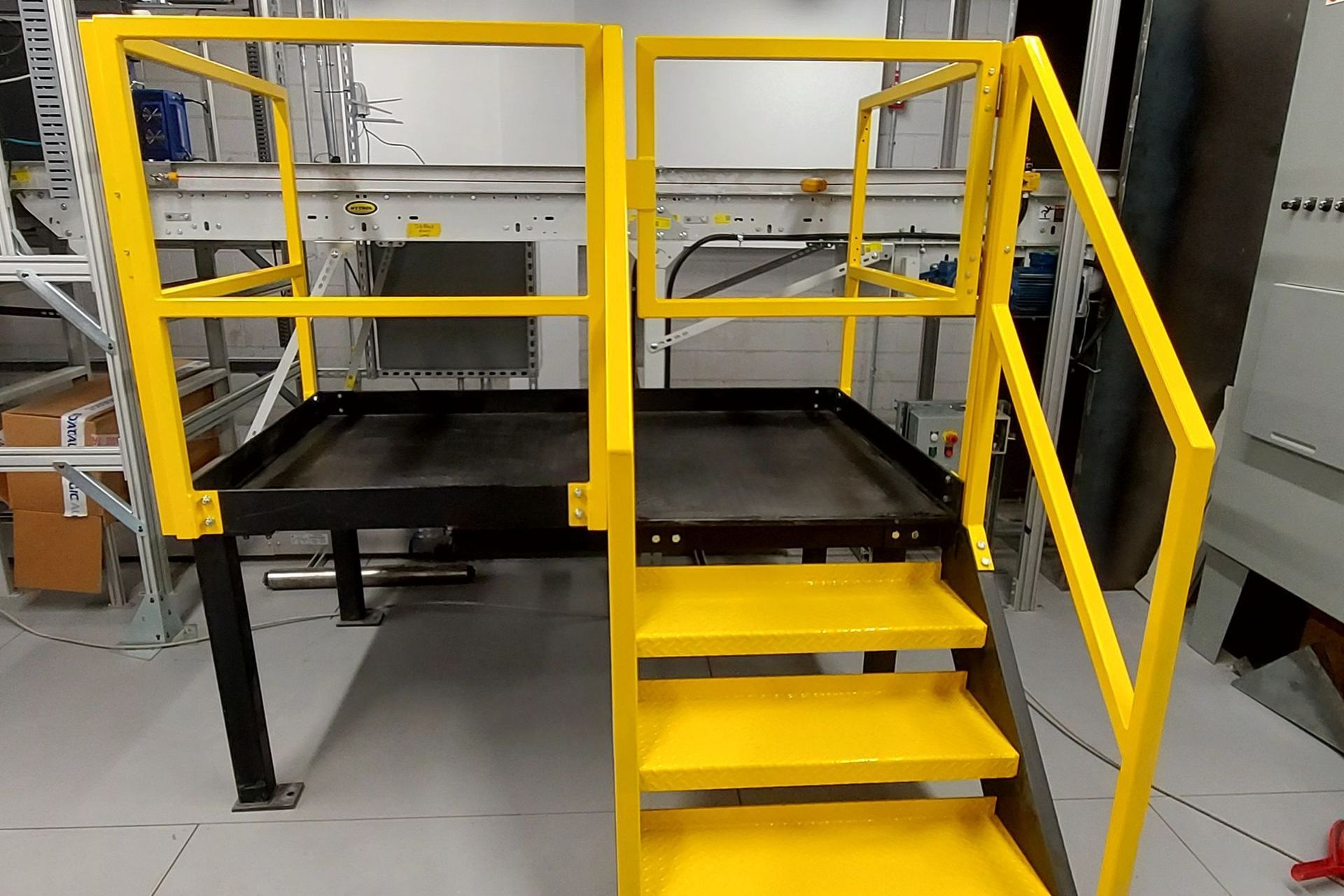 A set of yellow stairs with a yellow railing in a room.