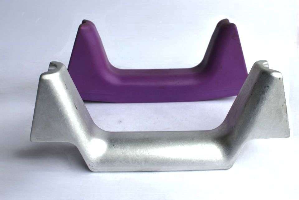 A purple and a silver object are on a white surface