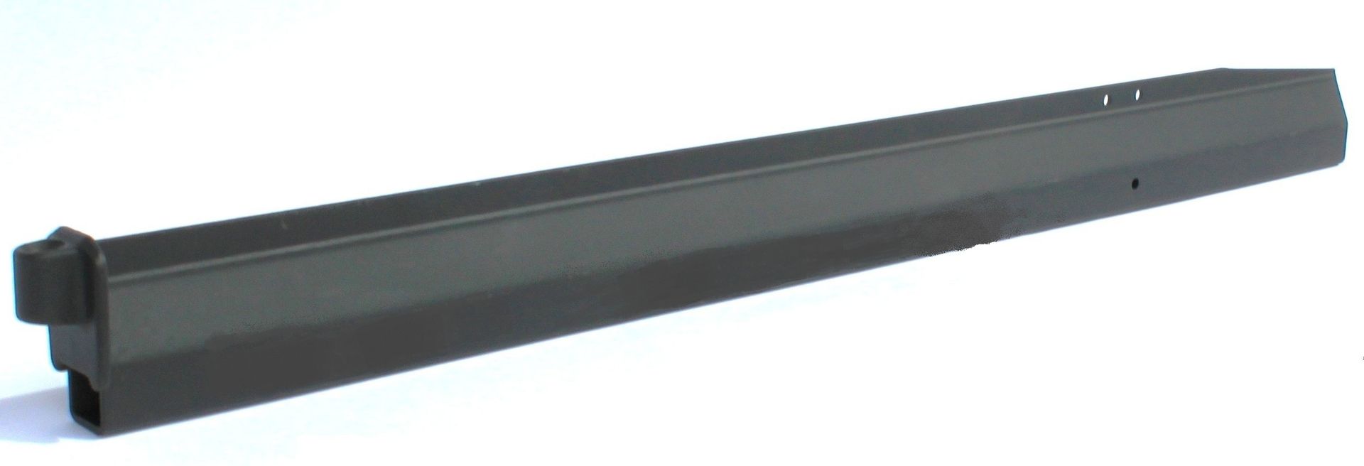 A black piece of metal is sitting on a white surface.