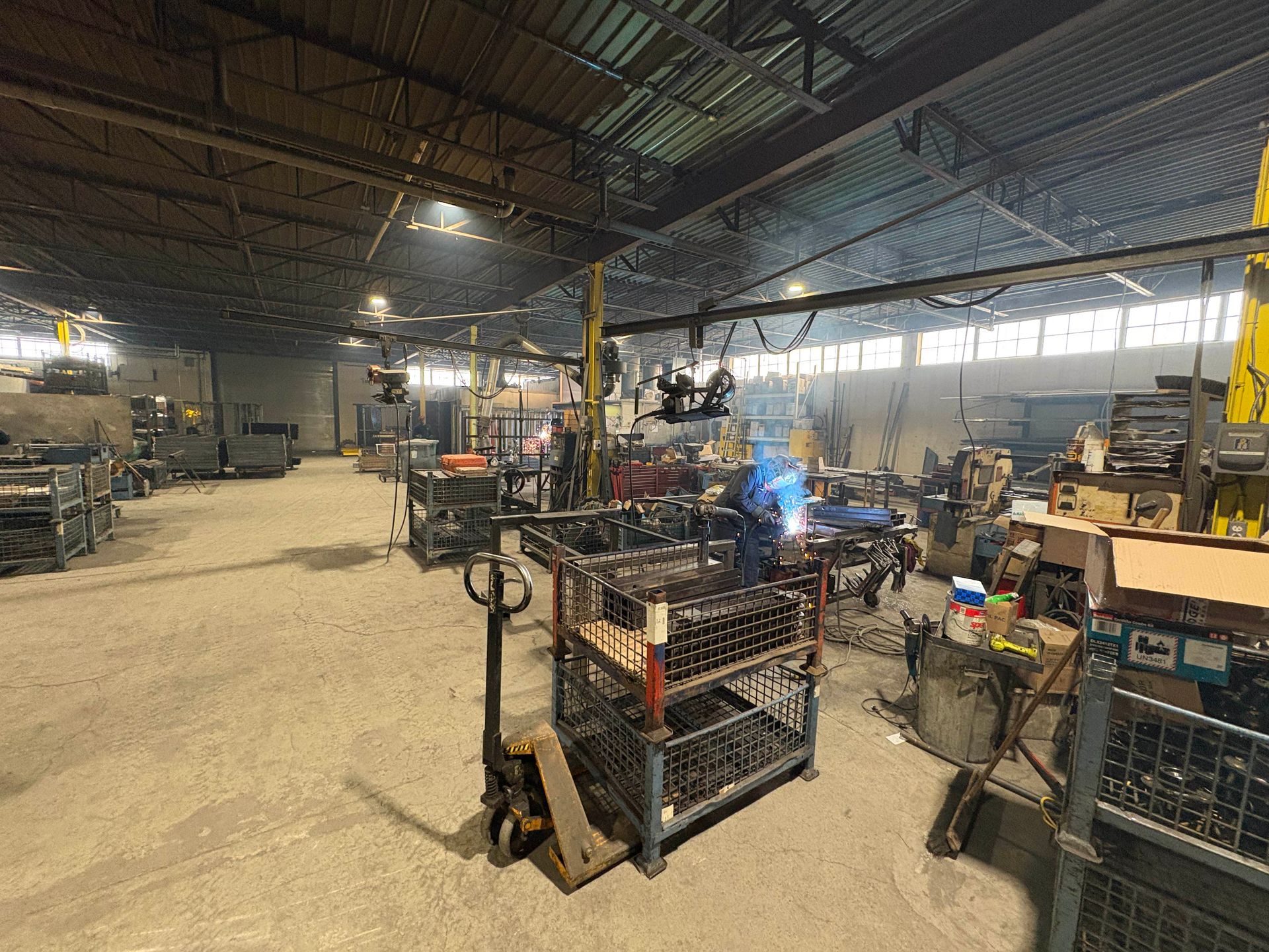 A large warehouse filled with lots of machinery and workers.