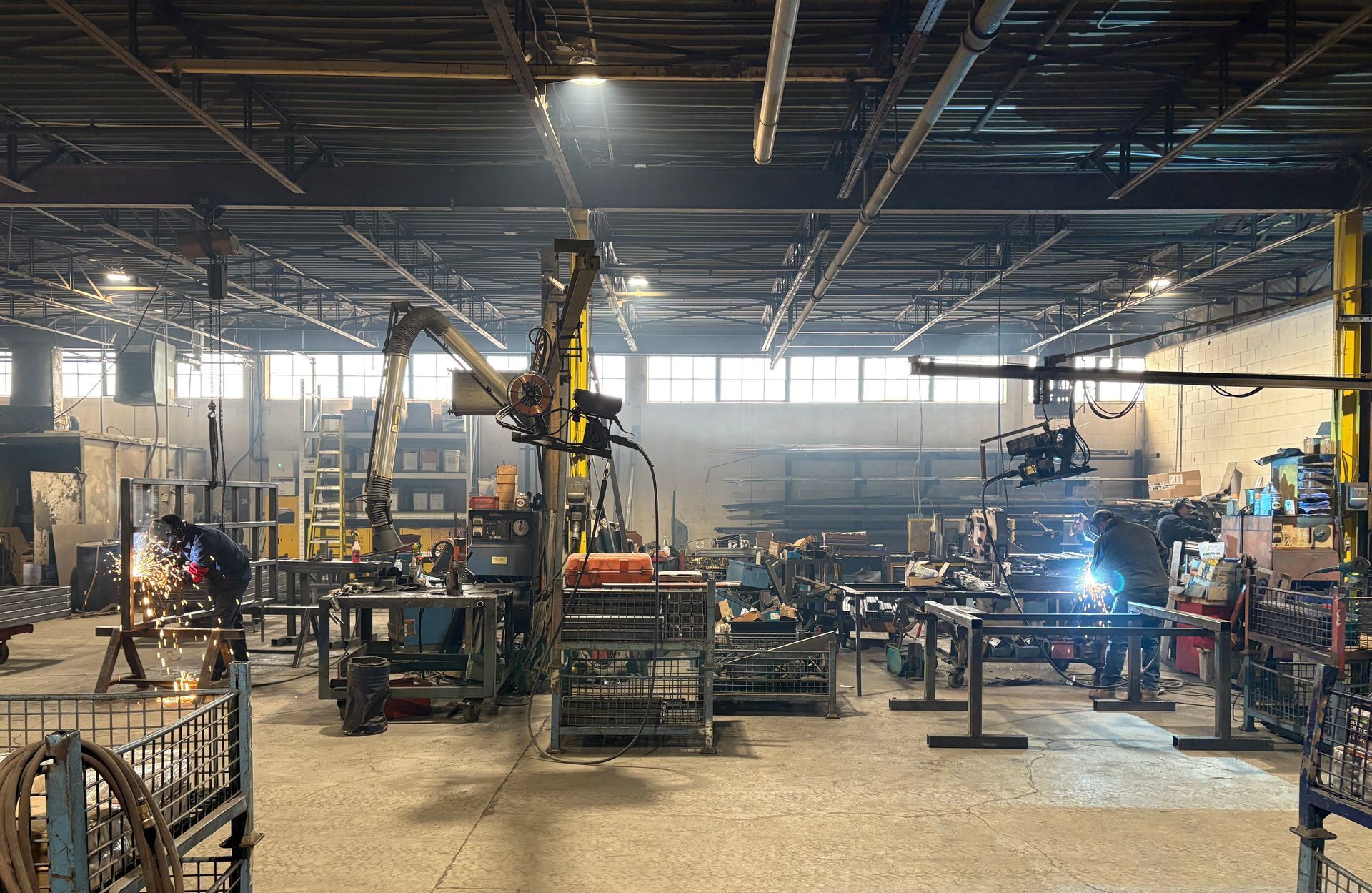 A large warehouse filled with lots of machinery and people.