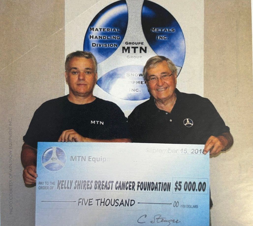 Two men holding a five thousand dollar check