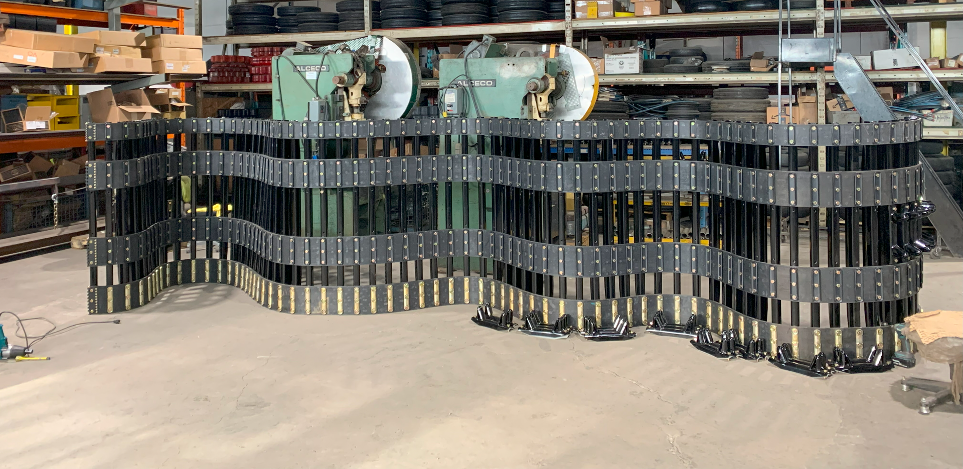 A large piece of metal is sitting on the ground in a warehouse.
