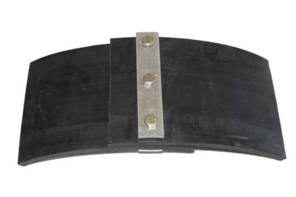 A black piece of rubber with a metal bracket attached to it.