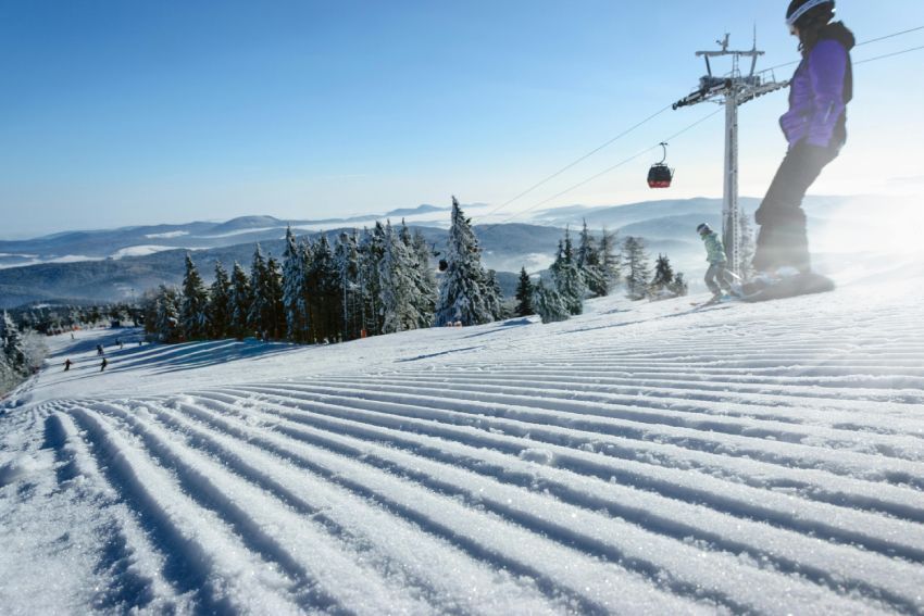 Close-up of a red snow grooming drag, showing the intricate design used for smoothing snow on ski trails.