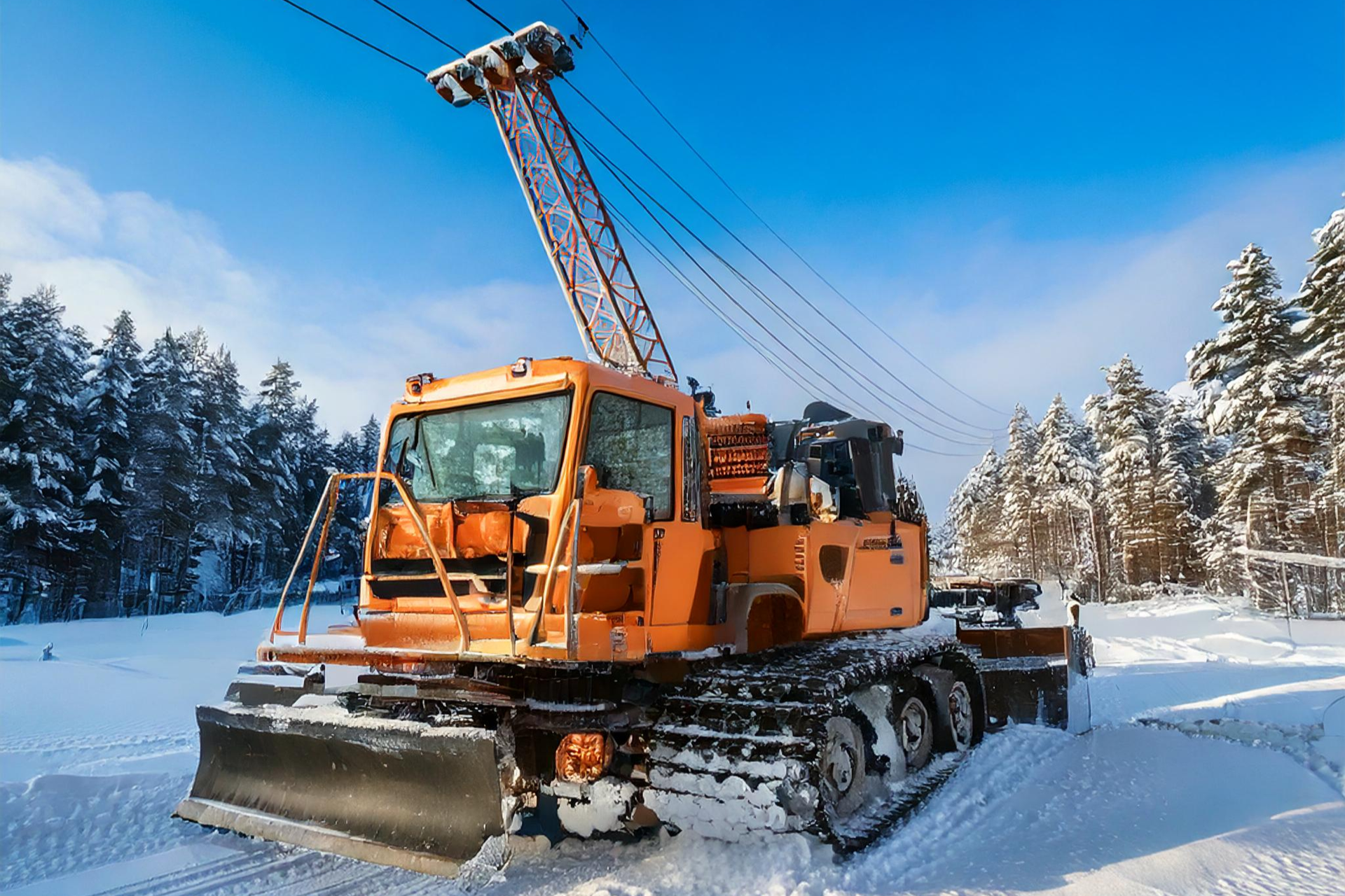 An orange snow plow is parked in the snow.