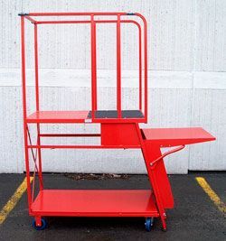 A red cart with a ladder attached to it is parked in a parking lot.