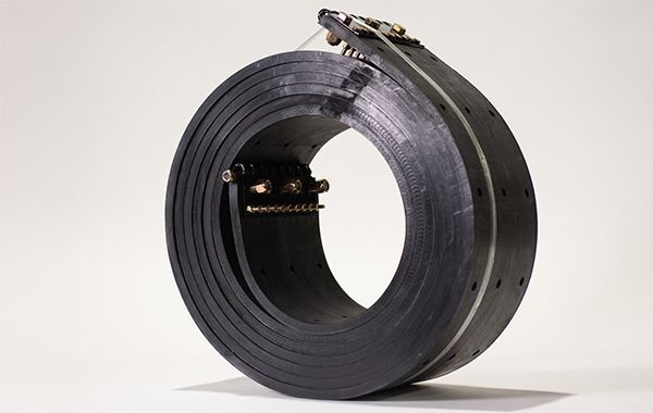 A black belt is sitting on a white surface