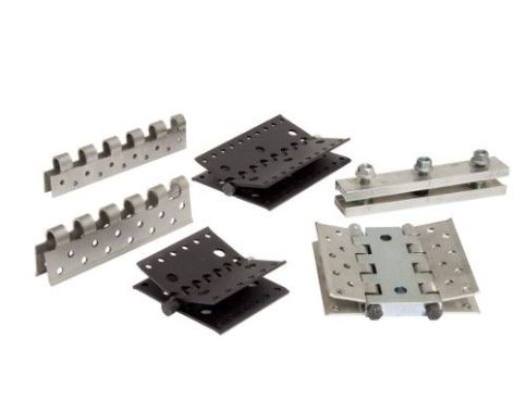 A group of metal pieces sitting on top of each other on a white surface.