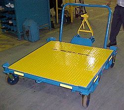 A man is standing next to a yellow and blue cart.