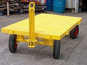 A yellow cart with red wheels is parked on the side of the road.