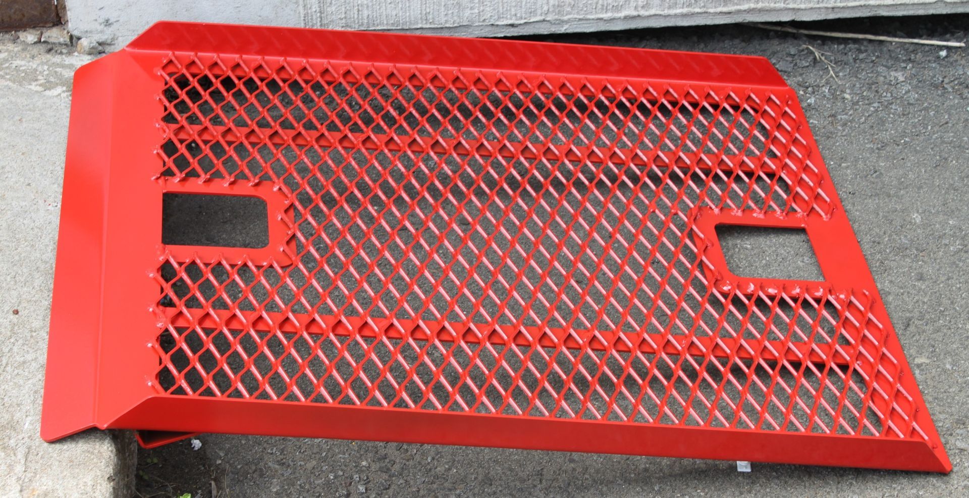 A red metal ramp is sitting on the ground