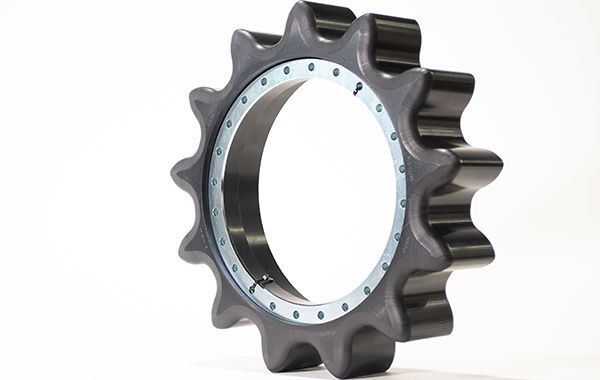 A close up of a gear on a white surface.