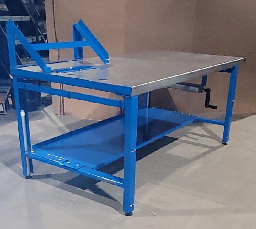 A blue metal workbench with a stainless steel top