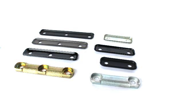 A bunch of metal pieces are sitting on top of each other on a white surface.