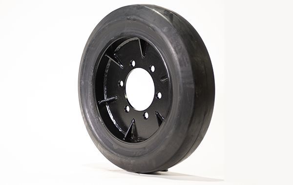 A close up of a black tire on a white background