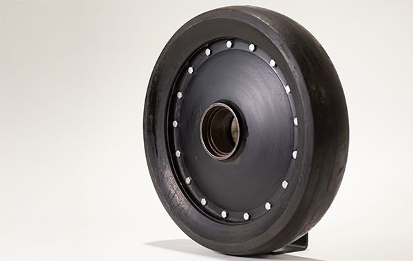A close up of a black wheel on a white surface