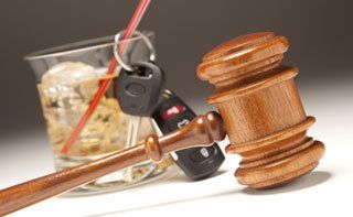 judge's gavel next to alcoholic drink and car keys