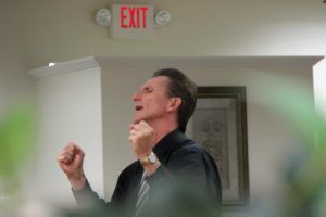 Man gesturing excitedly, speaking, with an 