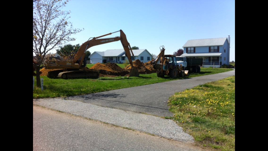 Yellow Excavator in an Empty Area — Newfield, NJ — Del Monte Waste Removal