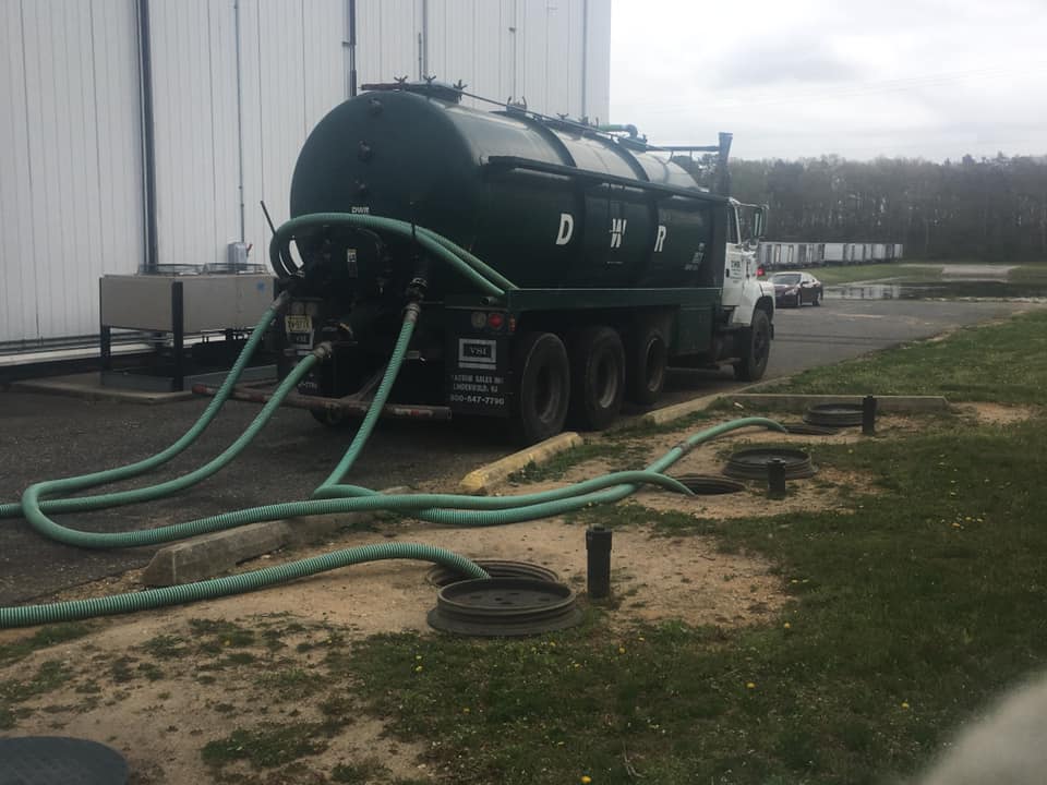 Truck With Green Tank for Pumping Waste — Newfield, NJ — Del Monte Waste Removal